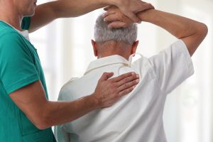Senior man having physical therapy for neck injury from whiplash