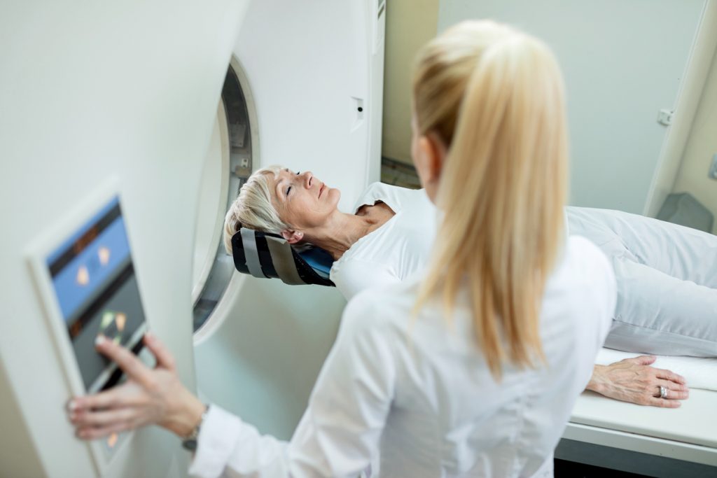 Senior women radiologist during MRI scan examination at clinic. 